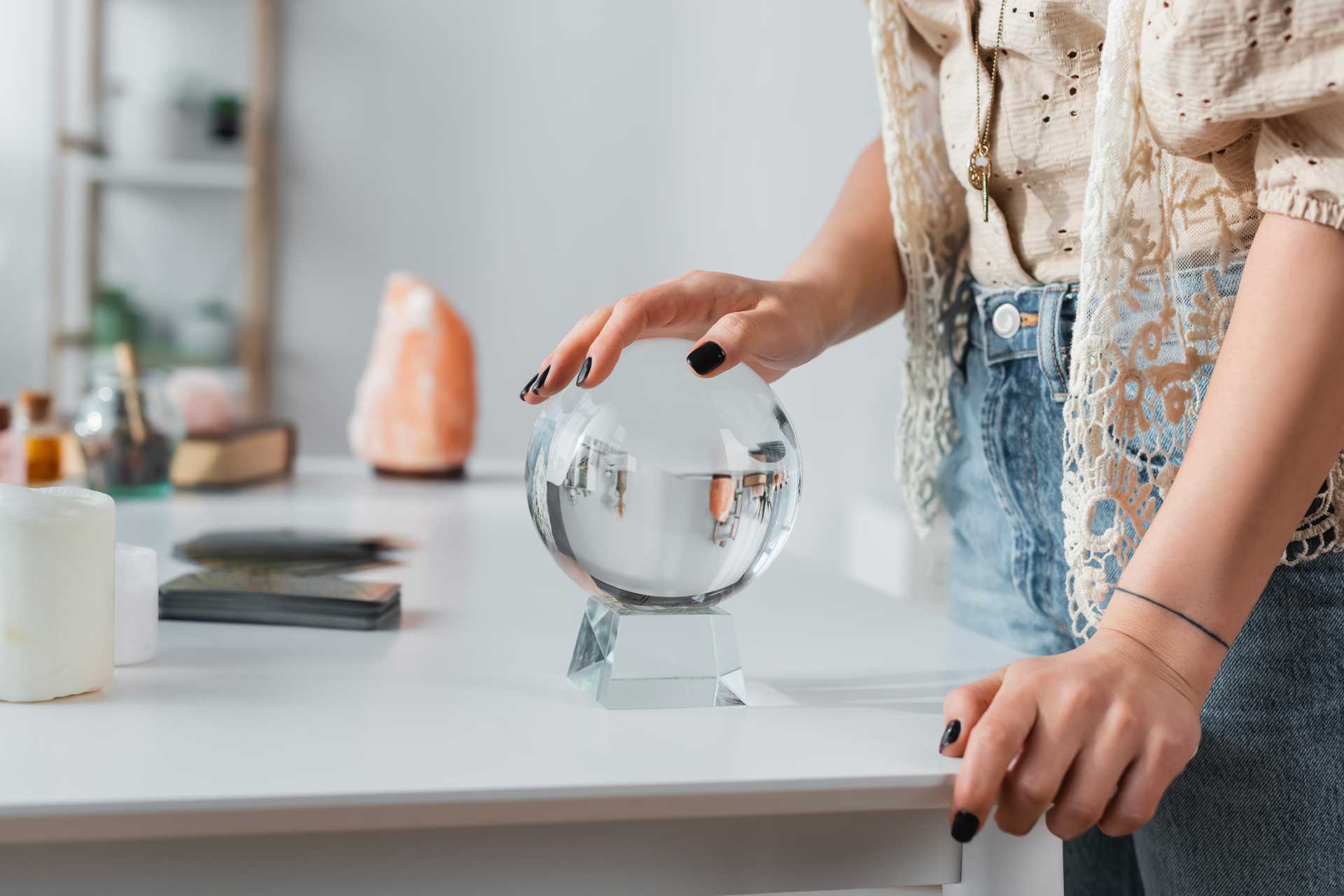 cropped-view-of-soothsayer-touching-orb-near-candl-2023-11-27-05-26-17-utc.jpg